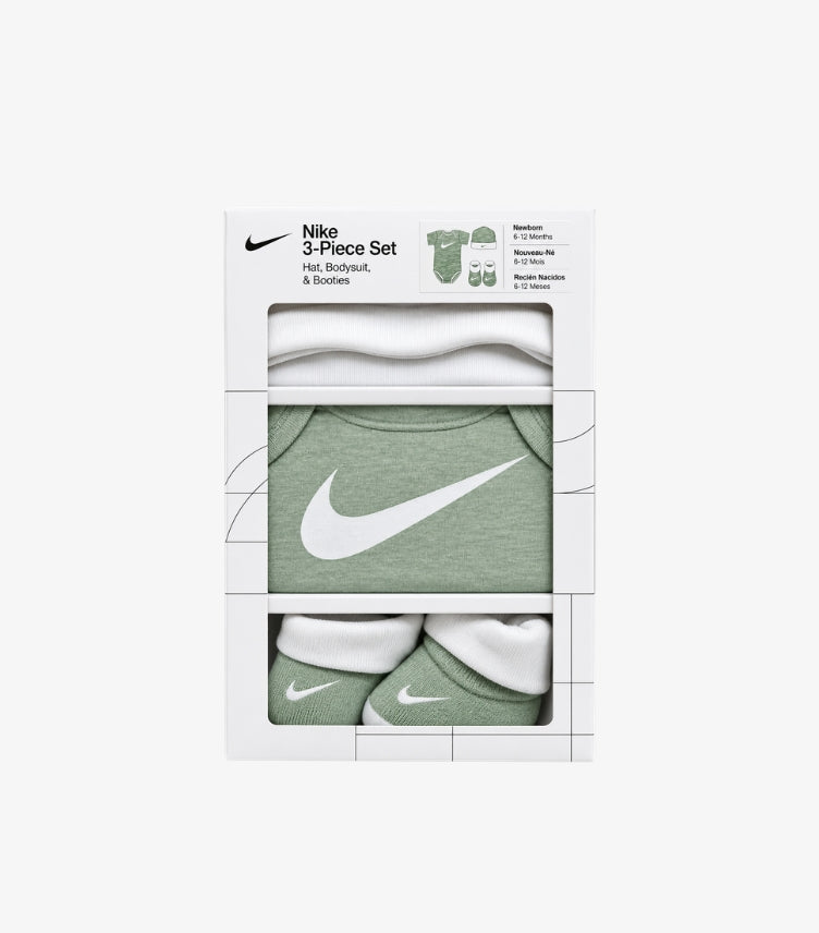 Nike baby 3-piece gift set in branded packaging featuring a Swoosh logo short sleeve bodysuit, matching baby hat and booties.