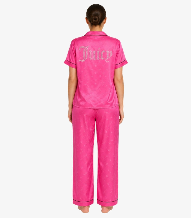 Back view of Juicy Couture women's pink satin pajama set featuring rhinestone logo, monogram print, short sleeves, and matching full-length pants.