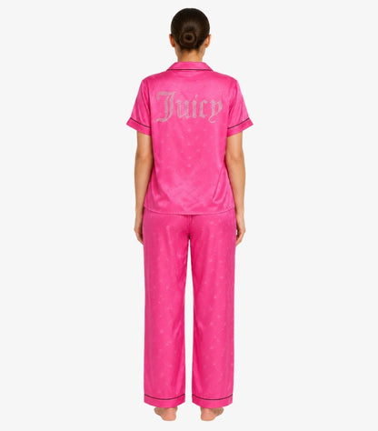 Back view of Juicy Couture women's pink satin pajama set featuring rhinestone logo, monogram print, short sleeves, and matching full-length pants.