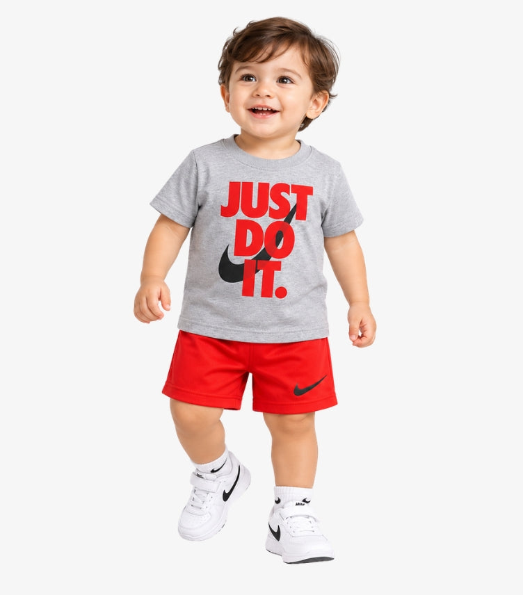 Toddler boy wearing Nike Just Do It graphic T-shirt and matching athletic shorts in front pose