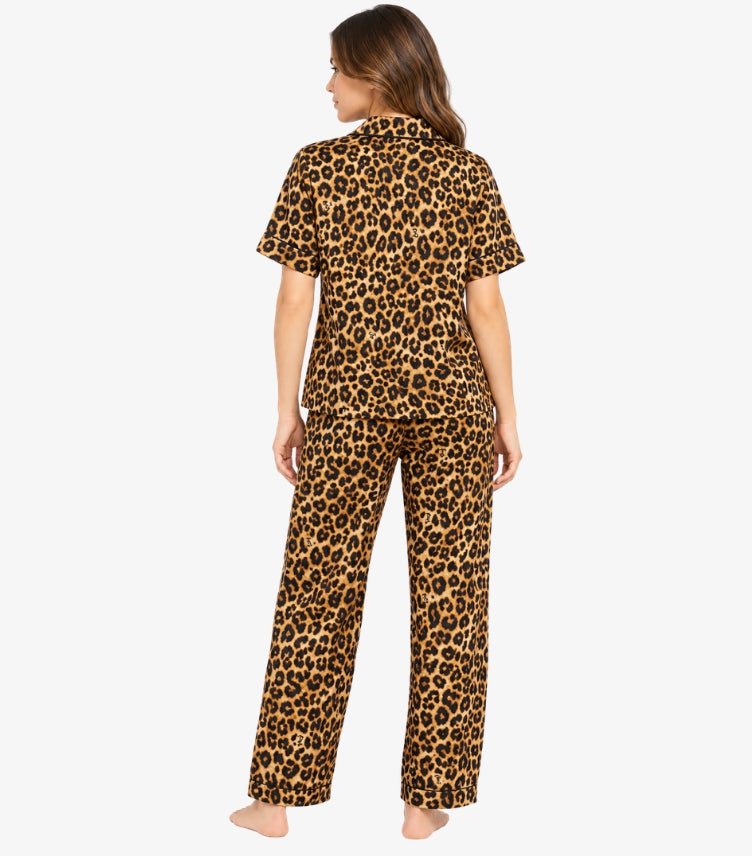Juicy Couture Women's Brown Leopard Print Pajama Set featuring an all-over black and brown animal print, short-sleeve shirt and matching full-length trousers, shown from the back.