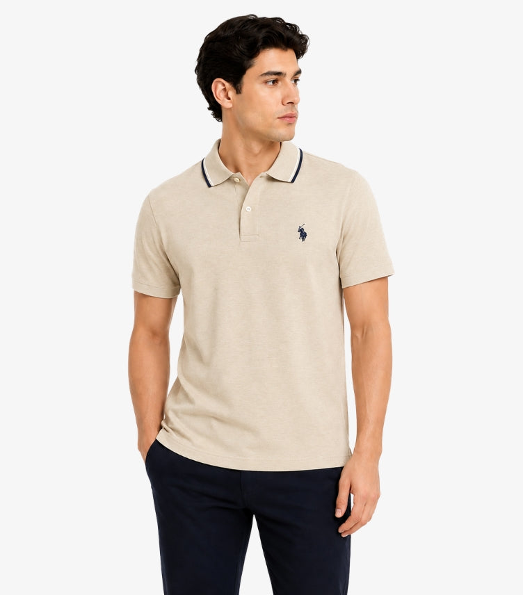 U.S. Polo Assn. men's oatmeal piqué polo shirt with navy tipped collar and embroidered horseman logo front on-model view