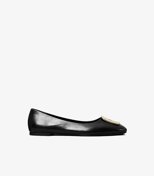 Side view of Tory Burch black square-toe ballet flat with oversized gold-tone Double T logo plaque