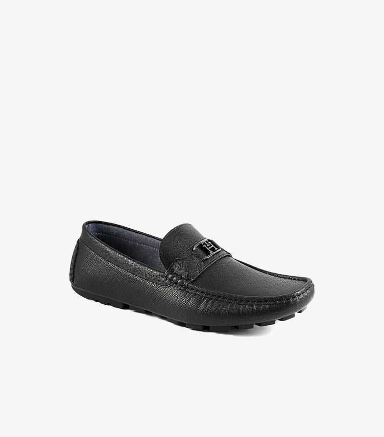 Angled front view of Tommy Hilfiger men's black leather driving shoes with slip-on design and premium textured leather finish.