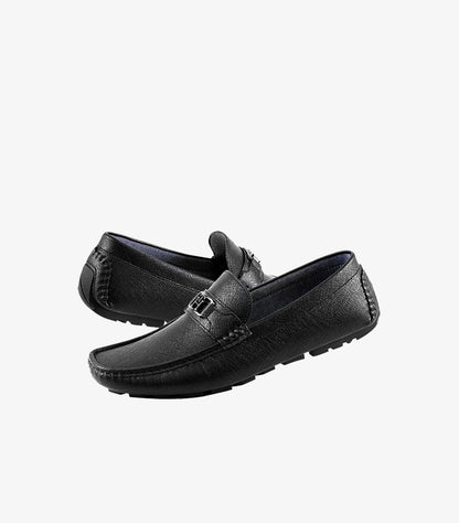 Tommy Hilfiger men's black leather driver loafers with textured finish, metal logo detail, and flexible driving sole, pair view.