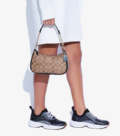 Coach Teri Signature canvas shoulder bag angled view showing CC monogram and zip-top closure
