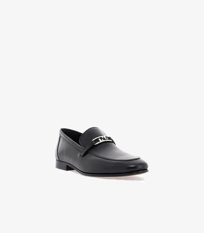 Three-quarter view of Fendi men’s leather loafers with slip-on construction, metal FF detail and low heel