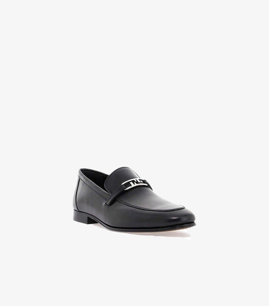 Three-quarter view of Fendi men’s leather loafers with slip-on construction, metal FF detail and low heel