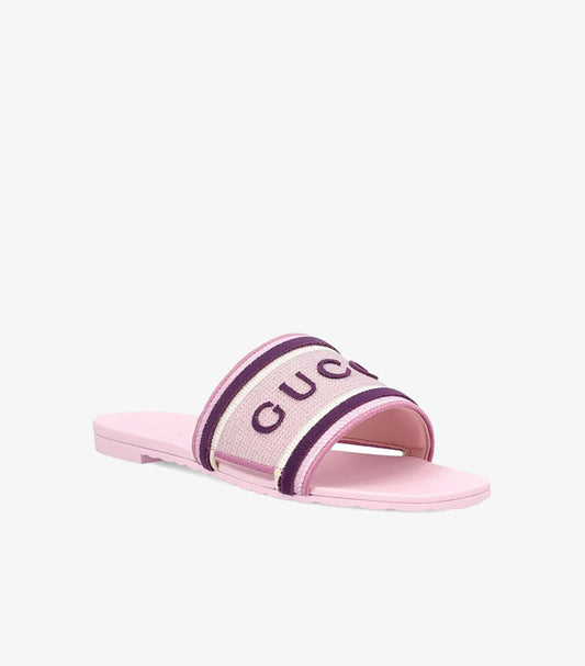 Angled side view of Gucci pink flat slide sandal with logo strap and square open toe