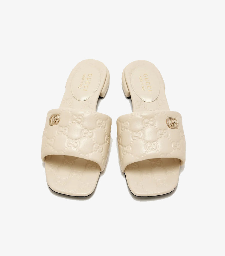 Gucci GG Matelassé cream leather flat slides top view showing Double G gold logo and GG monogram embossing