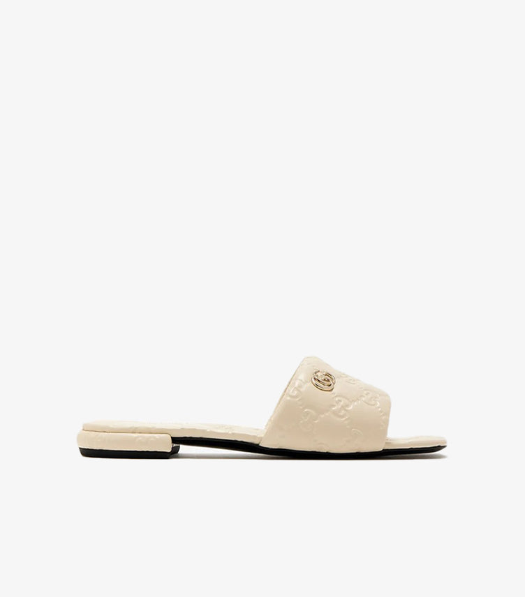 Gucci GG Matelassé cream leather flat slide sandal side profile view with gold Double G logo