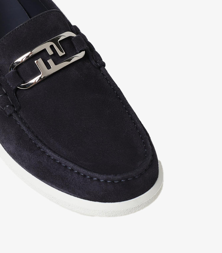 Close-up view of Fendi suede leather loafers highlighting signature FF metal detail and premium craftsmanship.