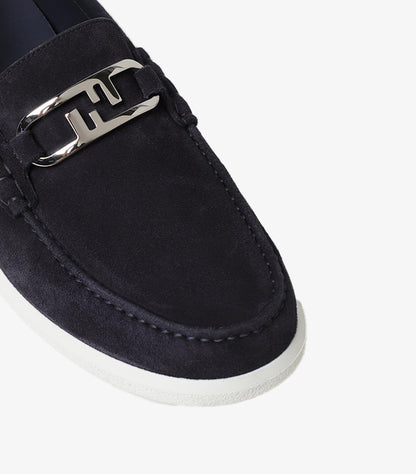 Close-up view of Fendi suede leather loafers highlighting signature FF metal detail and premium craftsmanship.
