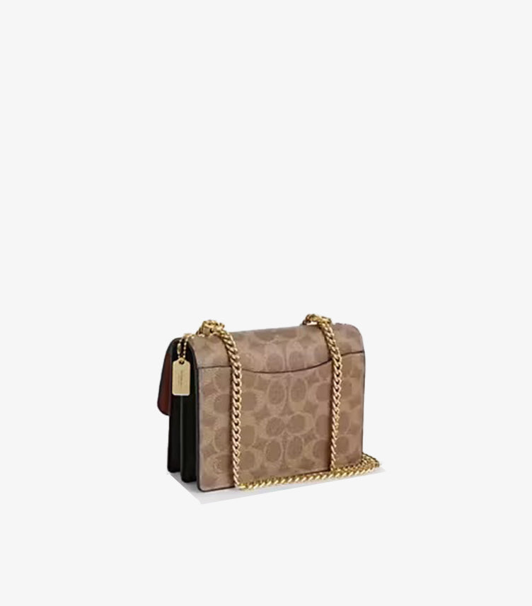 Coach Mini Klare crossbody bag side profile view showing 5cm depth and snap closure