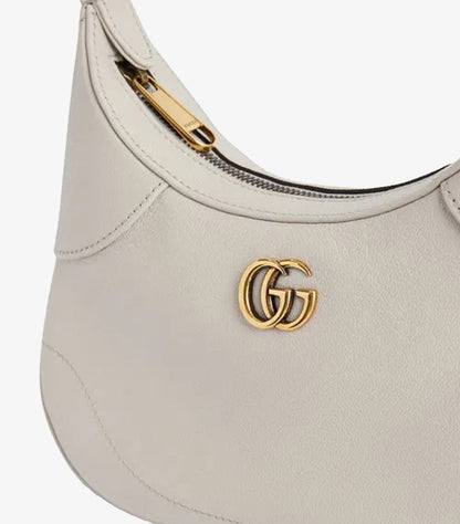 Gucci Aphrodite Small shoulder bag angled view showing curved base silhouette and zip closure