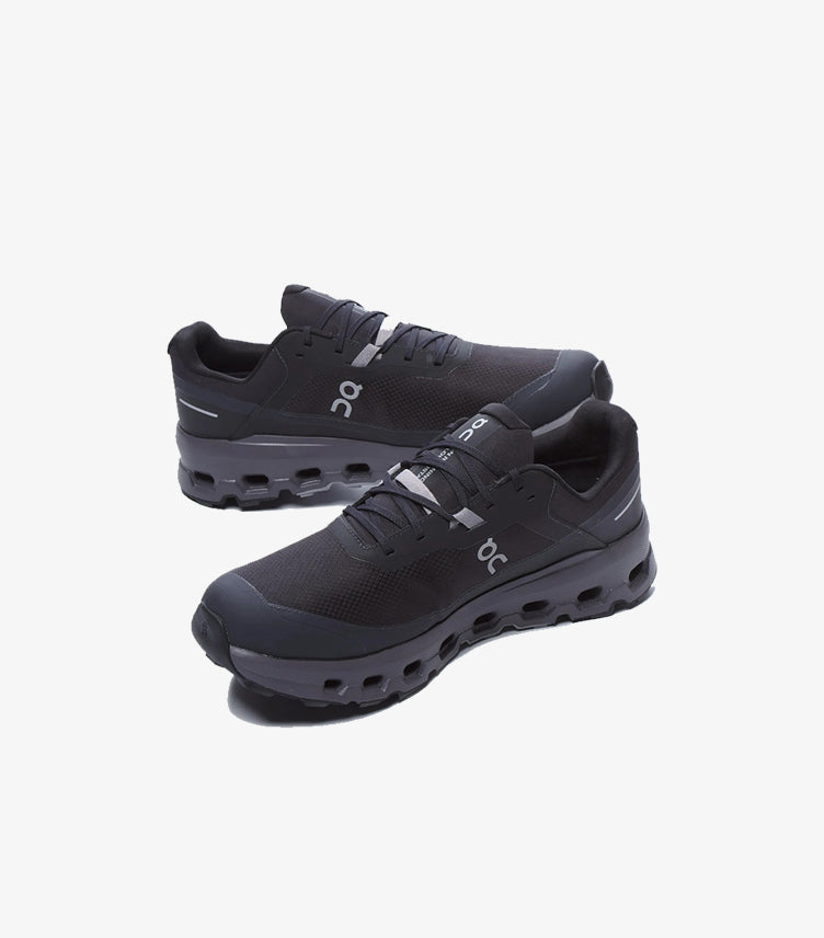 Angled view of black On Running waterproof trail shoes with lace-up design and cushioned CloudTec-style soles