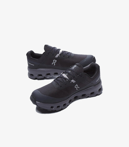 Angled view of black On Running waterproof trail shoes with lace-up design and cushioned CloudTec-style soles