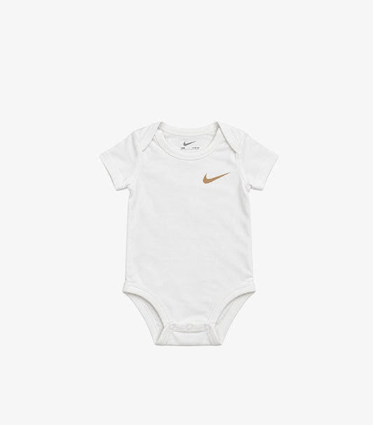 Front view of Nike baby white short-sleeve bodysuit with a gold-tone Swoosh chest logo, envelope neck and bottom poppers