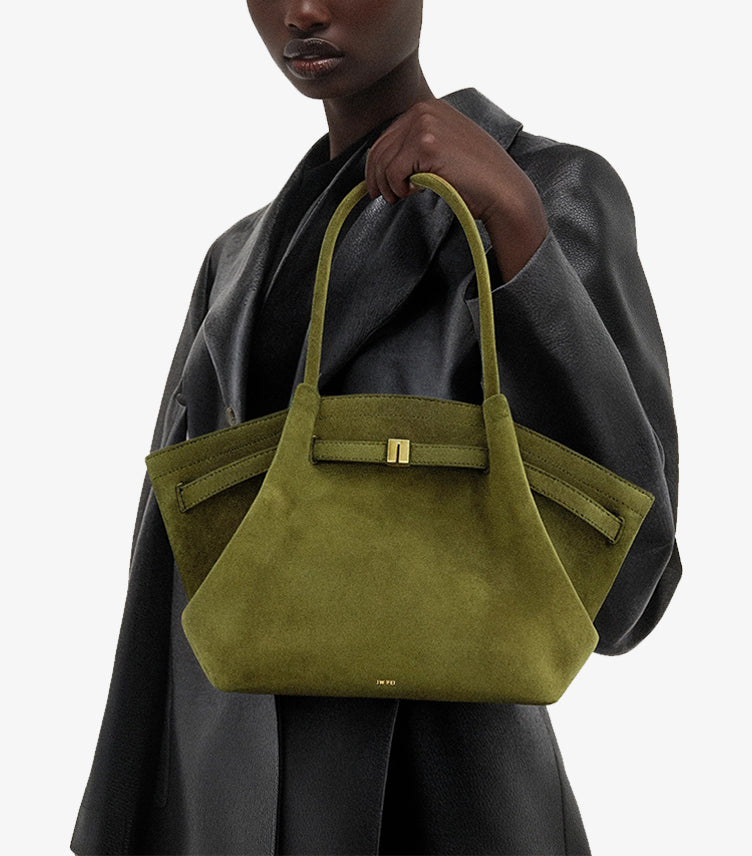 Woman carrying the JW PEI Hana medium faux-suede tote bag over her shoulder