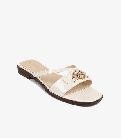GUESS Los Angeles cream patent leather cross-strap slide sandal angled view showing crystal triangle logo medallion and wood-effect heel