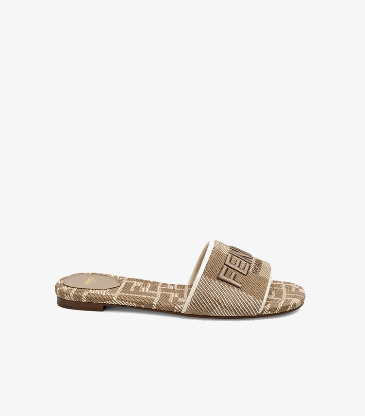 Side view of Fendi women’s FF monogram flat slide sandal with embroidered Fendi Roma logo strap