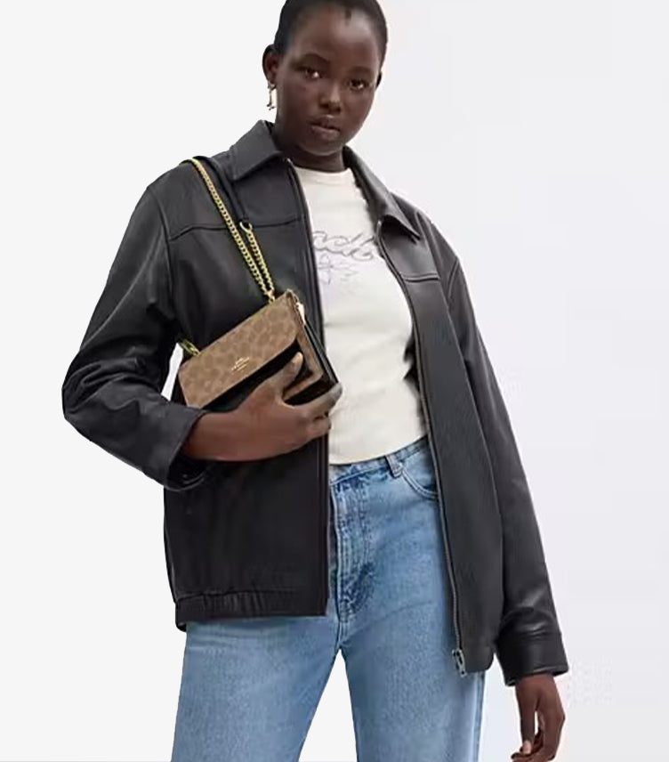 Coach Mini Klare Signature canvas crossbody bag angled view showing gold chain strap and CC monogram