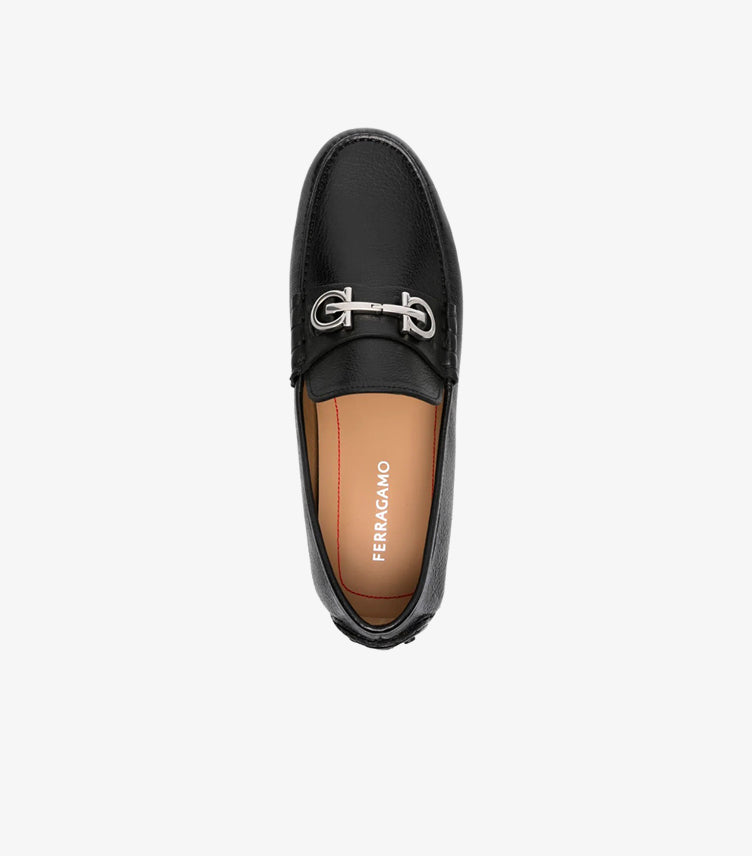 Ferragamo black Gancini driving loafer top-down view showing silver bit hardware and FERRAGAMO white branded insole with red accent