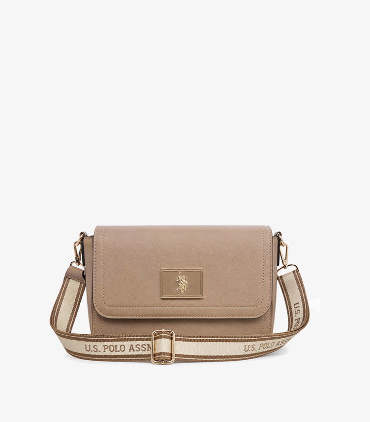 U.S. Polo Assn. beige crossbody bag with adjustable branded shoulder strap, gold-tone logo plaque, textured faux leather, and flap closure on a white background.
