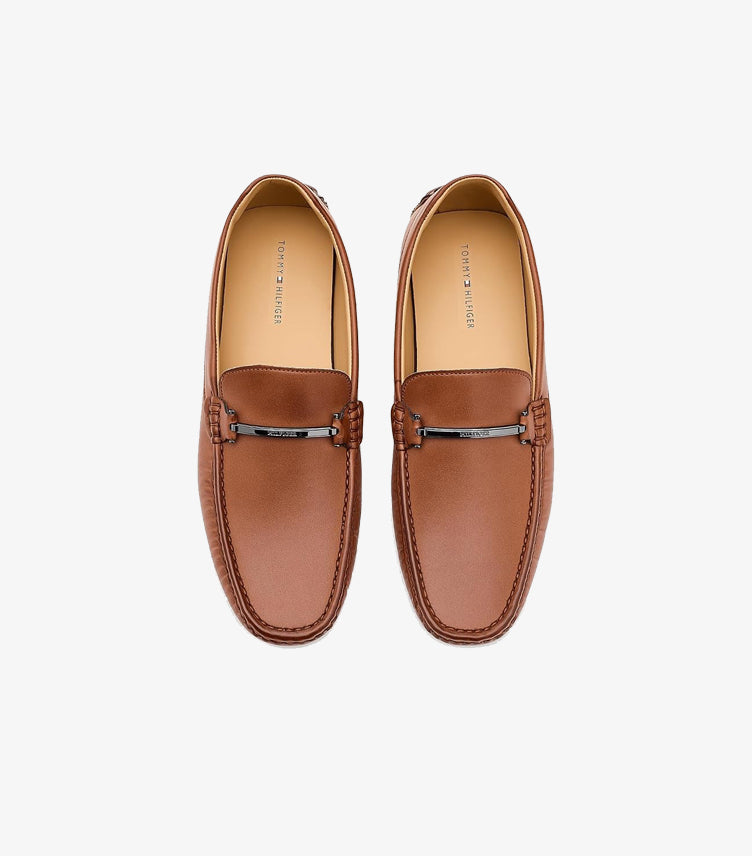 Top view of Tommy Hilfiger men’s brown leather driving loafers with branded metal bars and moccasin stitching