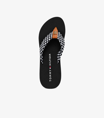 Top view of Tommy Hilfiger polka dot flip-flop sandals showing branded footbeds and logo details