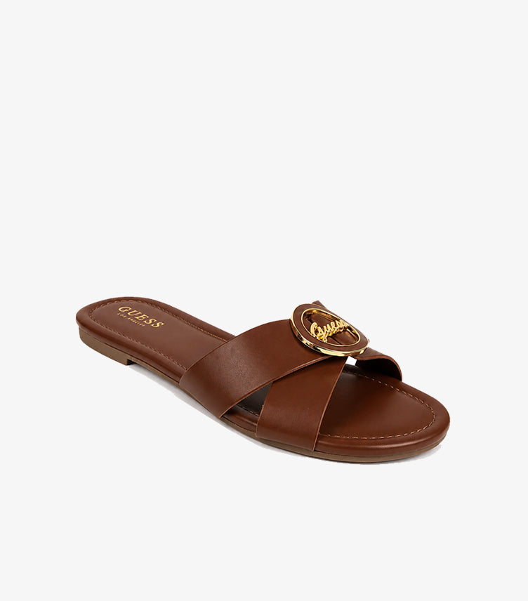 GUESS Los Angeles brown leather cross-strap flat slide sandal angled view showing gold script medallion