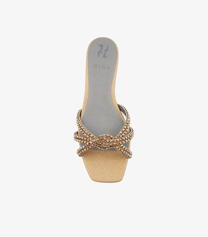 Top view of GINA champagne gold sandal featuring a sparkling crystal knot and metallic textured toe panel