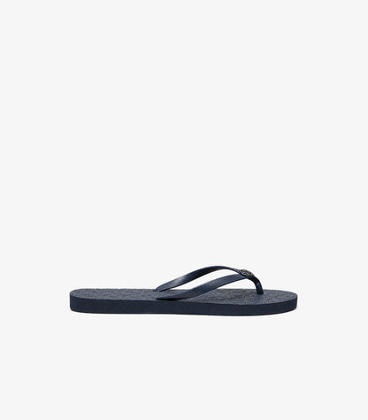 Side view of Tory Burch navy blue flat flip-flop with slim thong strap