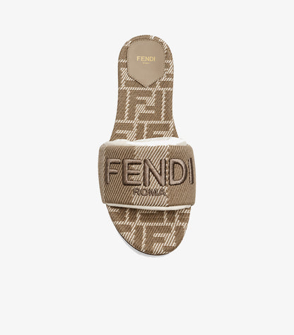Top view of Fendi women’s beige FF monogram slide sandal showing the logo strap and patterned footbed