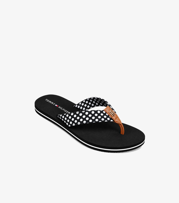 Pair of Tommy Hilfiger polka dot flip-flop sandals displayed in an angled product view