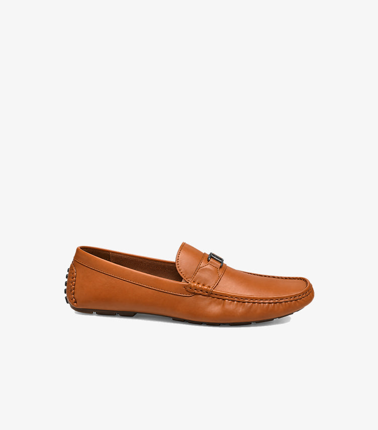 Side view of Tommy Hilfiger men’s tan slip-on driving loafer with low-profile sole and stitched detailing