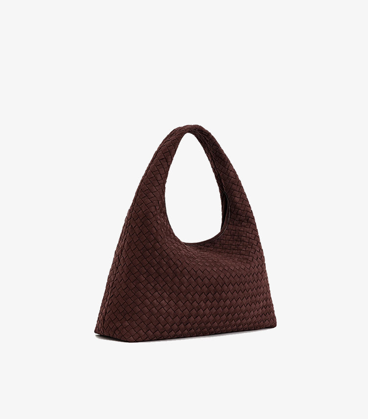 Angled view of JW PEI woven tote bag showing its interlaced texture, side profile and broad base