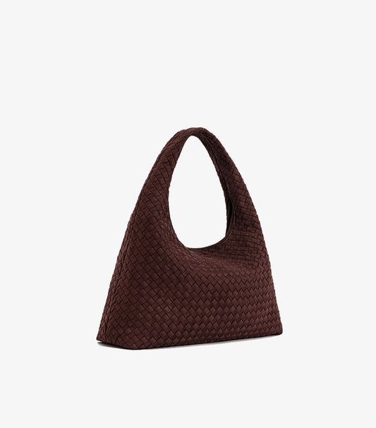 Angled view of JW PEI woven tote bag showing its interlaced texture, side profile and broad base