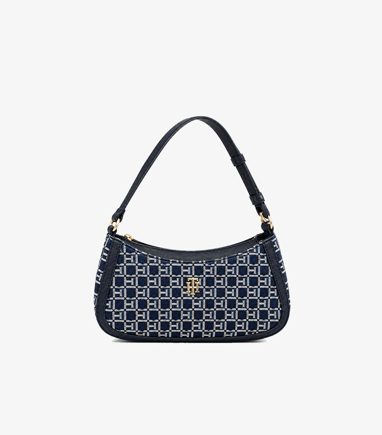 Front view of Tommy Hilfiger monogram shoulder bag with navy trim, top zip closure and gold-tone logo hardware