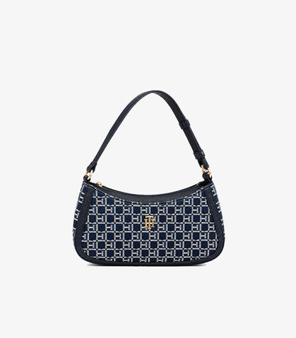 Front view of Tommy Hilfiger monogram shoulder bag with navy trim, top zip closure and gold-tone logo hardware