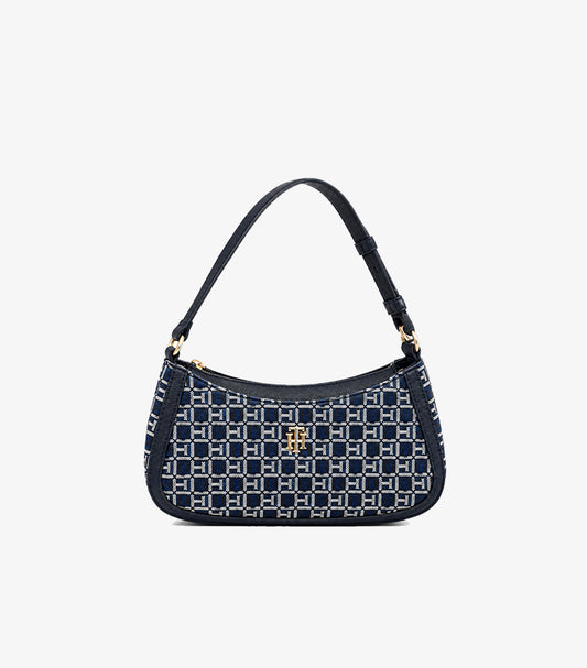 Front view of Tommy Hilfiger monogram shoulder bag with navy trim, top zip closure and gold-tone logo hardware
