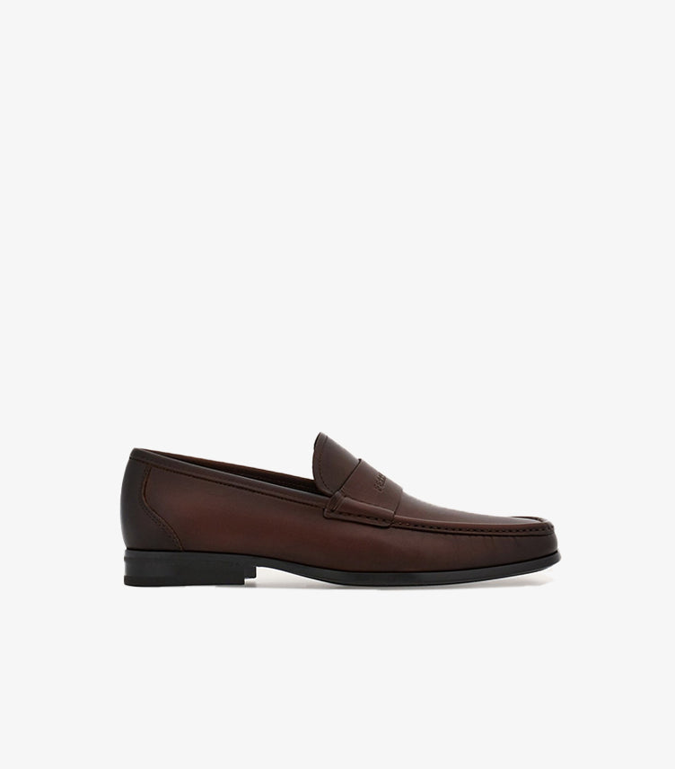 Side view of Ferragamo men’s brown leather loafer with low black heel