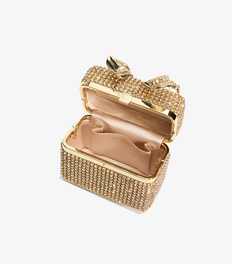 Open Self-Portrait gold crystal clutch showing satin-lined interior