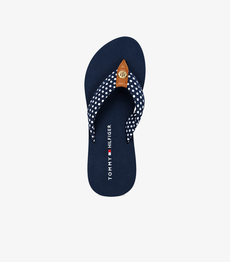 Overhead view of Tommy Hilfiger polka dot flip-flop sandal with branded footbed and TH emblem
