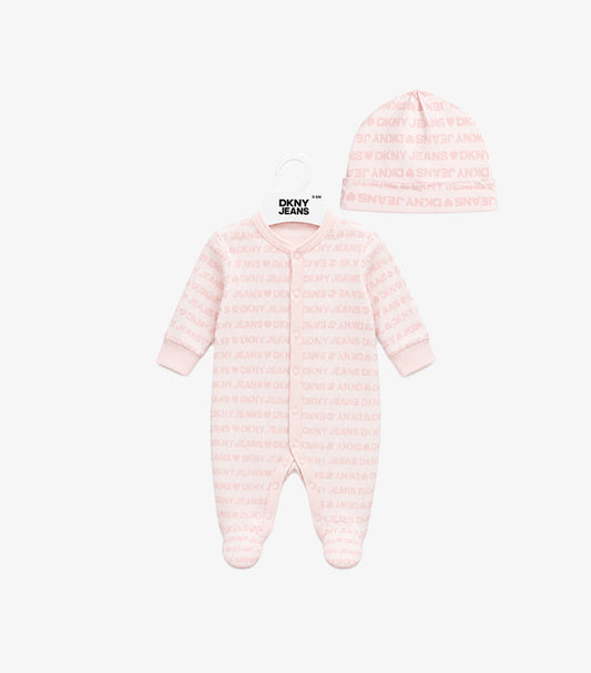 Front view of DKNY Jeans baby girls’ pale pink logo-print footed sleepsuit and matching hat set.