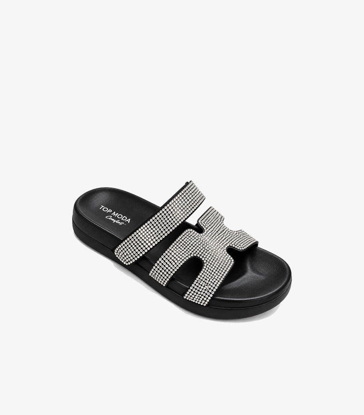 Angled view of Top Moda black rhinestone platform slides showing the cushioned footbed and cut-out front strap