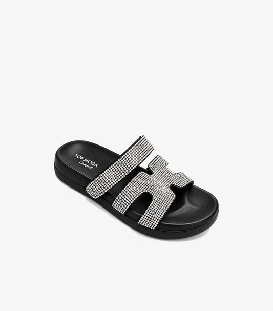 Angled view of Top Moda black rhinestone platform slides showing the cushioned footbed and cut-out front strap