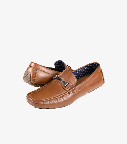 Three-quarter view of Tommy Hilfiger men’s brown leather driving loafers with branded metal bars and moccasin stitching