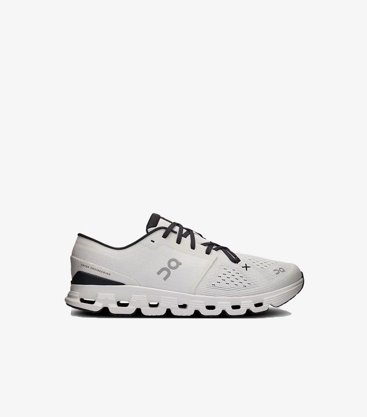 Side view of On Running Cloud X training shoe with logo detailing, reinforced heel and cushioned pod sole