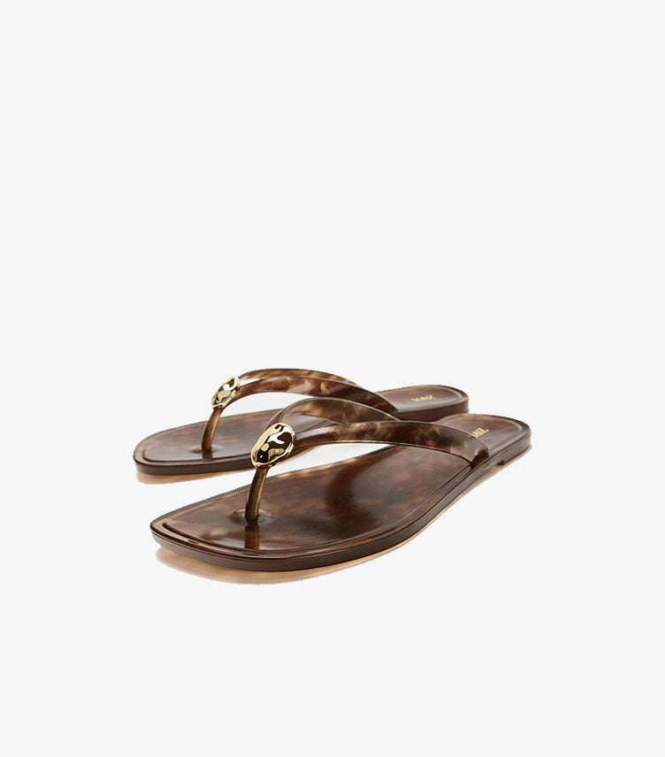 Angled view of Zara tortoiseshell-effect flat sandals with square toes and sculptural gold-tone details